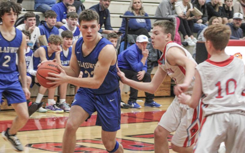 Colton Pfenninger makes a move toward the basket. Pfenninger led the Flying G’s junior varsity to victory with 14 points.