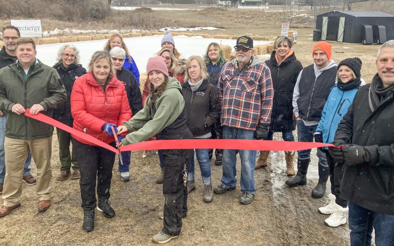 Gladwin Interim City Administrator Kimberly Hines and City Park Manager Sabrina Battjes handle the big scissors Saturday at a ribbon cutting to open the new North Park Winter Wonderland.