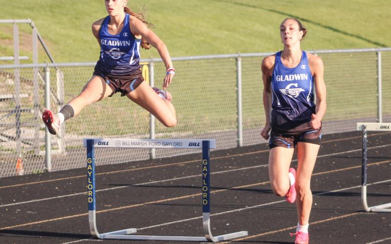 Gladwin’s Bree Visser takes flight as two-time All-State teammate Ava Gary picks up steam during the 300 hurdles at the Northern Michigan Meet of Champions last Tuesday.