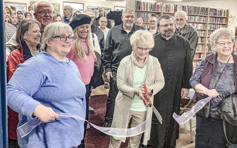 A ribbon cutting ceremony was held last Wednesday to celebrate the expansion of Sacred Heart Mission. Wielding the scissors is Florence DeShano, flanked by Director of the Mission Yvette Keast, Father Marcel Portelli and Chairman of the Board Pam Weaver.