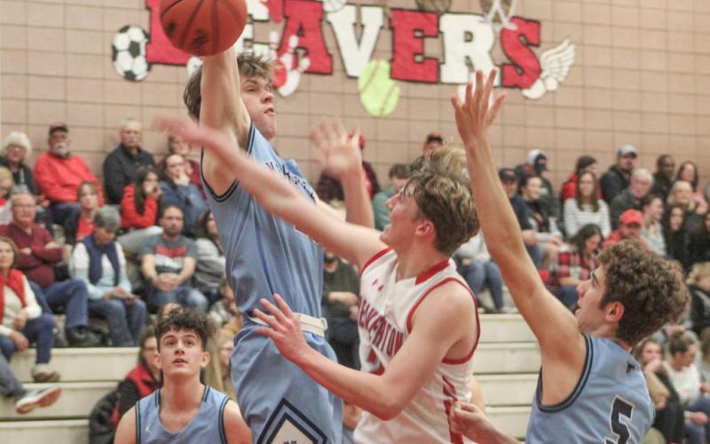 Beaverton’s Ian Roberts contests a Meridian shot in the paint during Friday night’s loss to the top team in the Jack Pine Conference.