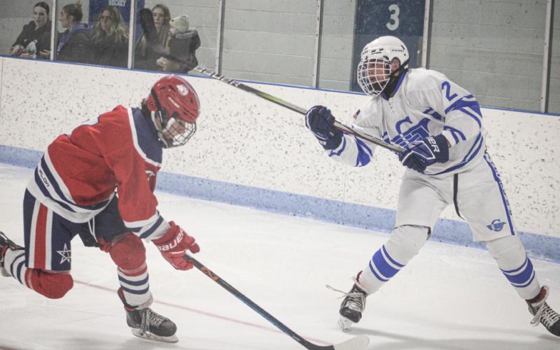 Gladwin’s Trinity Hair clears the puck out of the zone during a game last season. The defenseman returns for his sophomore season when the puck drops this weekend.