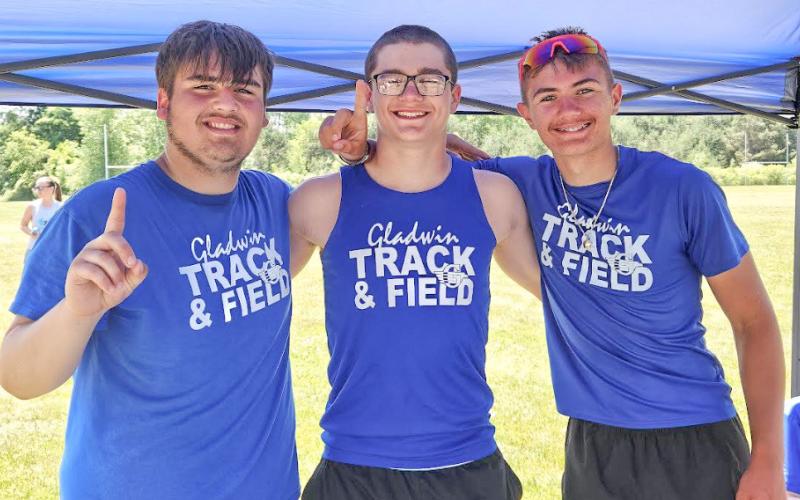 Liam Gary, Michael Brasseur, and Liam Pohlman waiting to compete in the shot put.