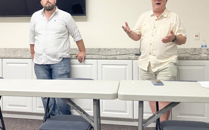 Environmental advocates Sean McBrearty (left) and David Holtz address a crowd of citizens Monday evening at the Gladwin County District Library, detailing their opposition to the proposed construction of an oil tunnel beneath the Straits of Mackinac.
