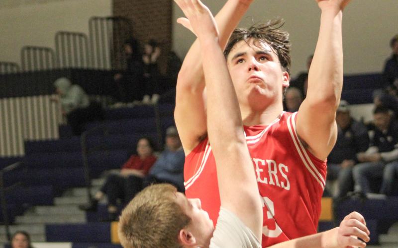 Beaverton’s Landon Love goes up and over a Shepherd defender during a victory Thursday night that clinched the Jack Pine Conference Division 2 title for the Beavers.