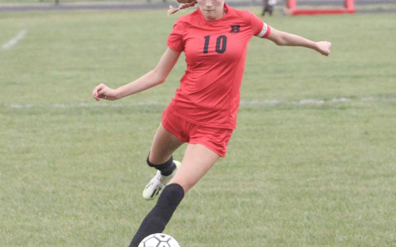Charity Danielak gets ready to let fly during Beaverton’s 11-0 victory over Oscoda last week, the first soccer district tourney win in school history.
