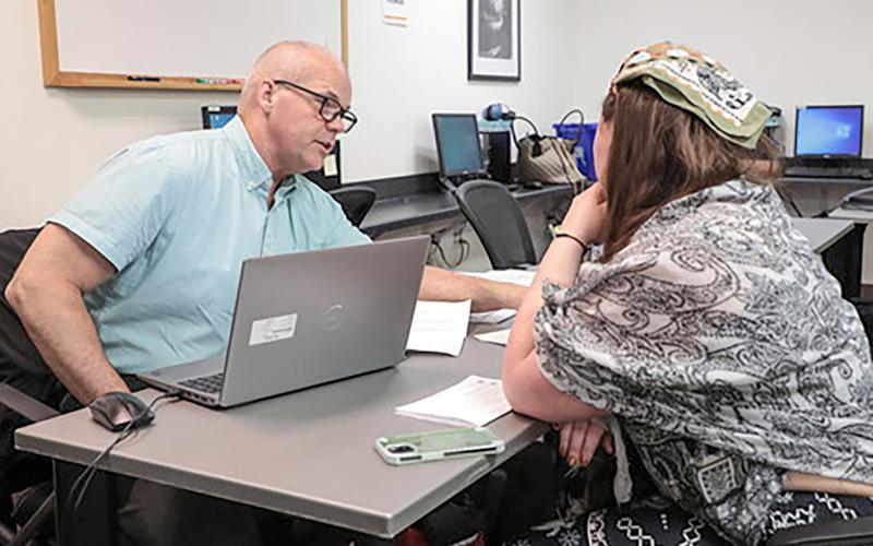 Jeff Thompson with the MDOS triage team provides expert guidance on driver’s license restoration to an attendee at the Gladwin clinic.