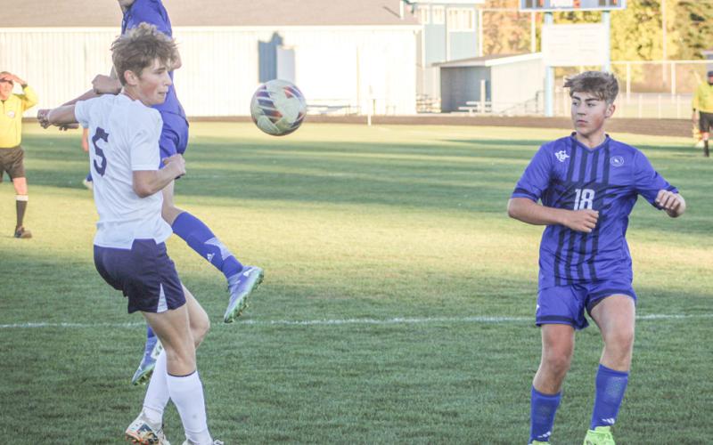 Gladwin’s Barrett Williams watches a ball headed by George Whittaker sail toward the net during last week’s loss to Shepherd.