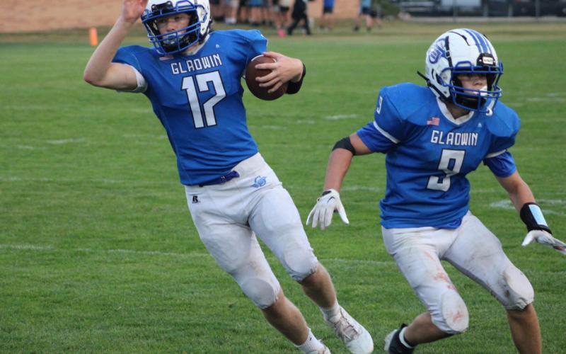 Caden McKeever cuts behind blocker Kolten Greaves during a recent Gladwin junior varsity football game.