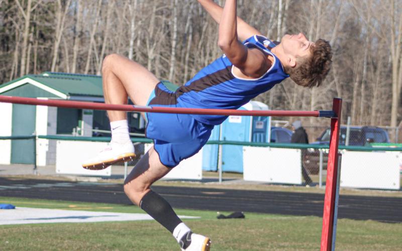Gladwin’s Erik Roggow clears the bar in the high jump during last Wednesday’s meet at Clare.