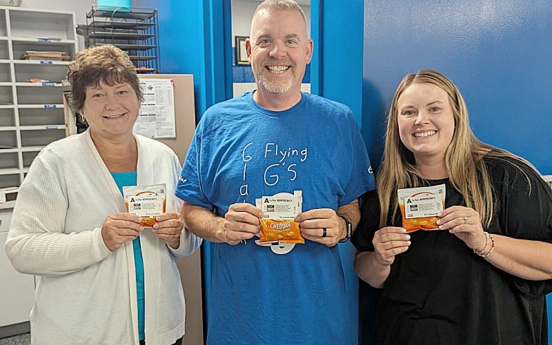 Holding their snack appreciation bags are Gladwin Intermediate School Secretary, Jen Slabic; GIS Principal, Bryan Randle; and GIS Librarian and Special Education Secretary, Ciara Robinette.
