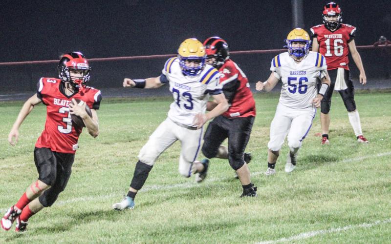 Beaverton’s Kamdyn Avila turns the corner and runs to daylight during the first half of Friday night’s one-point loss to visiting Harrison.
