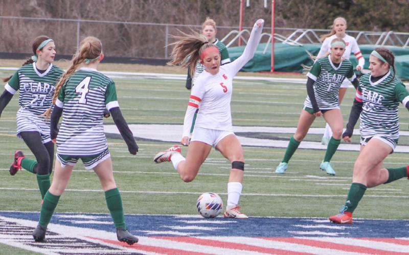 Beaverton’s Piper Carland tees up a shot during last week’s tough 1-0 loss at Clare in the first game of the season.