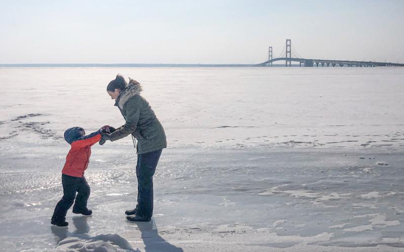 Frozen bodies of water should be checked carefully before braving the ice. While there is no perfectly reliable method to determine if ice is safe, you can use a spud, needle bar or auger to test the thickness and quality of ice. Inset photo: always wear ice picks secured to your chest so they are within easy reach in case you break through the ice.
