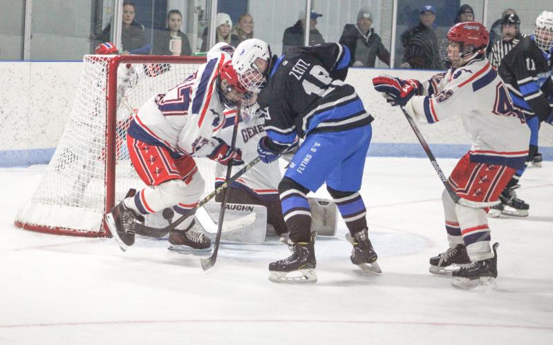 Gladwin’s Jeff Zeitz tries to bang in a shot from tight quarters in front of the net during Saturday’s victory over Genesee.