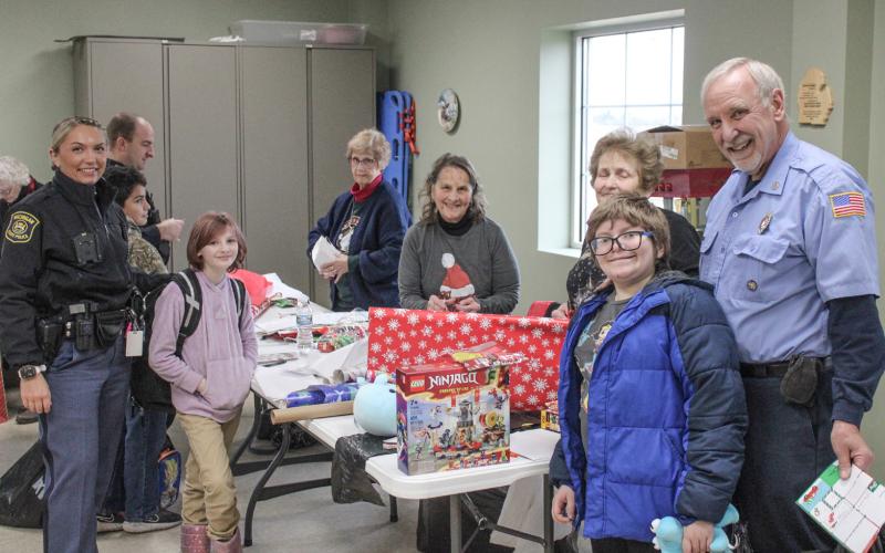 After a big Christmas shopping trip, the next step is to wrap the presents and that’s what this bunch was up to Thursday at the Beaverton Fire Dept. during the annual Shop With A Hero festivities.