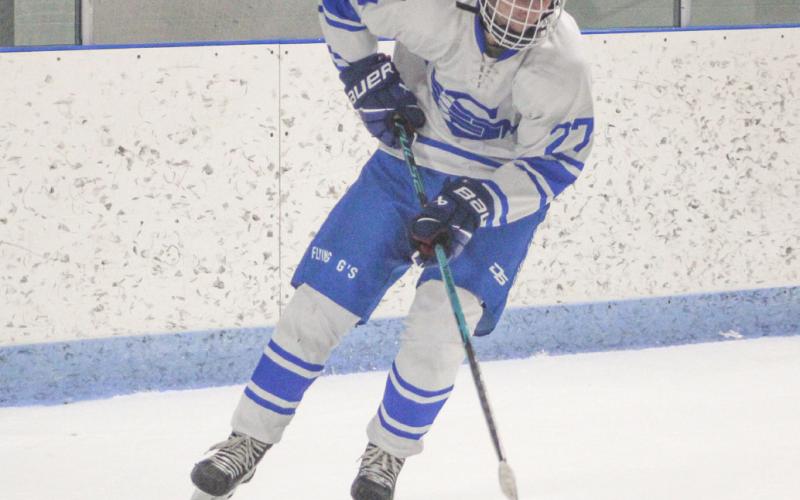 Gladwin’s Logan Shell tries to control a rolling puck as he moves toward the slot during Saturday’s loss to Petoskey.