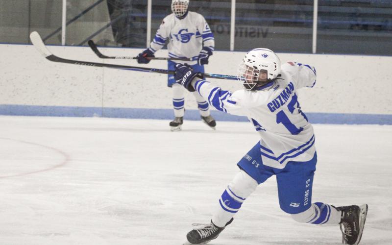 Gladwin’s Braeden Guzman follows through on a shot during the third period of Saturday’s loss to visiting Petoskey.