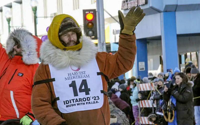 Defending champion Brent Sass, wearing bib No. 14, waves to the crowd during the Iditarod Trail Sled Dog Race’s ceremonial start in downtown Anchorage, Alaska, on Saturday, March 4, 2023. Sass withdrew from this year’s race, Saturday, March 11, 2023, citing concerns for his health. AP PHOTO/MARK THIESSEN