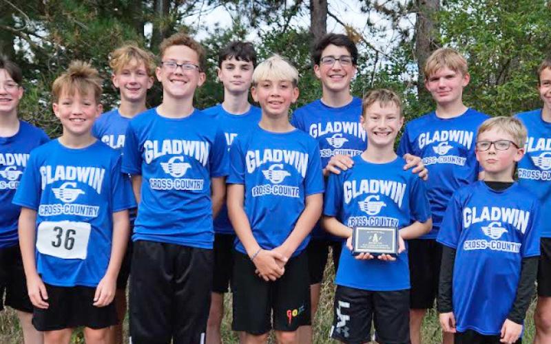 The Gladwin Junior High Boys Cross Country Team ran their way to a second place overall finish in Mt. Pleasant on Oct. 11. They are pictured here after their meet with their plaque. There were 137 runners and nine teams in the race.