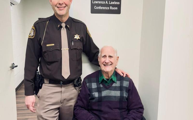 Lt. Troy Rabidue poses with his grandfather, former Sheriff Larry Lawless in Lawless’ former home.