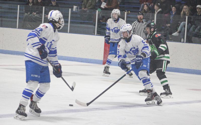 Gladwin’s Caden McKeever gets the puck out of the zone Saturday when the Flying G’s beat visiting Manistique to snap a three-game losing streak.