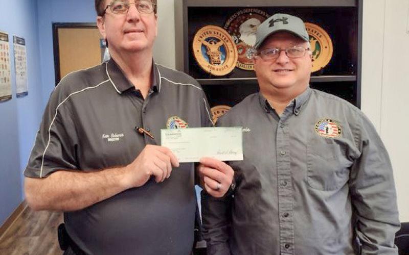 The Michigan Masonic Charitable Foundation presented with a donation to the Gladwin County Veterans Relief Fund aiding veterans and their families to help provide heating, electricity, and food. Pictured are Ken Roberts, Gladwin County Veterans Affairs Director (left) and Jamie McCoy, Veteran Service Officer (right).