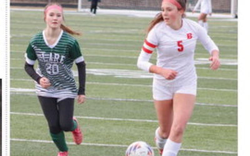 Beaverton’s Piper Carland races past a Clare defender and looks toward the net during last week’s season-opening tie.