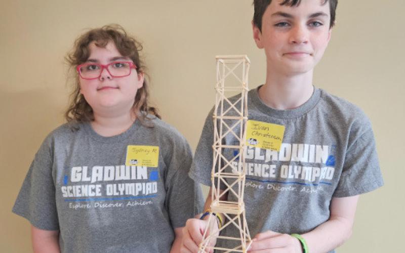 Sydney Myers and Ivan Christensen with their tower that weighed 24 grams. The tower was able to hold 17 kilograms.