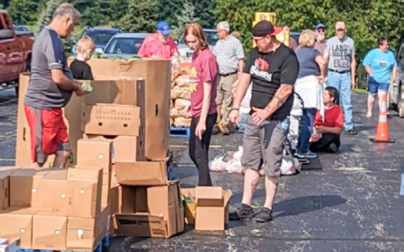 Volunteers sorting and assisting food into cars at Christ the King.