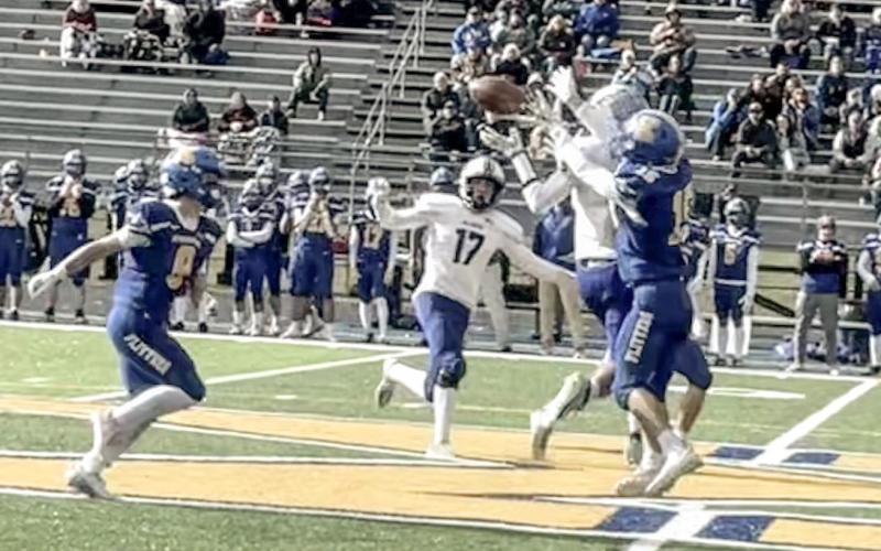 Gladwin’s Logan Walters fights through traffic to make a catch Saturday in the first round of the Division 5 playoffs at Kingsford. PHOTO PROVIDED BY ALAN DONALDSON