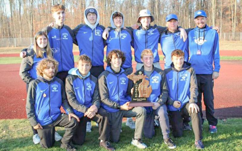 The Gladwin boys’ cross country team poses with the hardware after winning a second straight Division 2 regional title Friday at Benzie Central.
