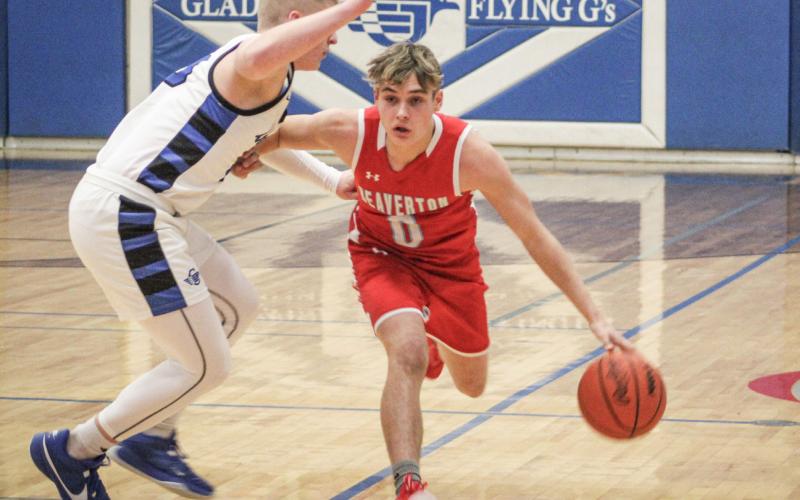 Gladwin’s Jayden Mieske applies defensive pressure to Beaverton ball-handler Caiden Loar during Round 1 of the basketball battle for Butch last Tuesday night. The Flying G’s pulled out a tough 57-49 victory.