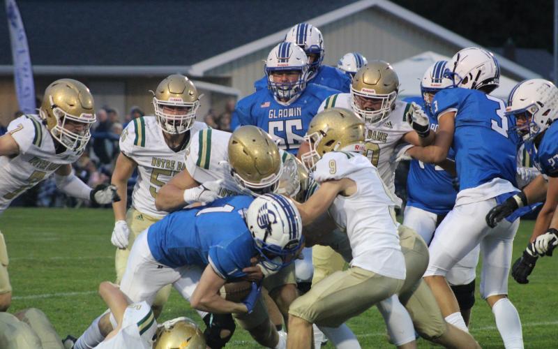 Gladwin’s Trace Corlew breaks a tackle during Friday night’s homecoming battle with undefeated Pontiac Notre Dame Prep.