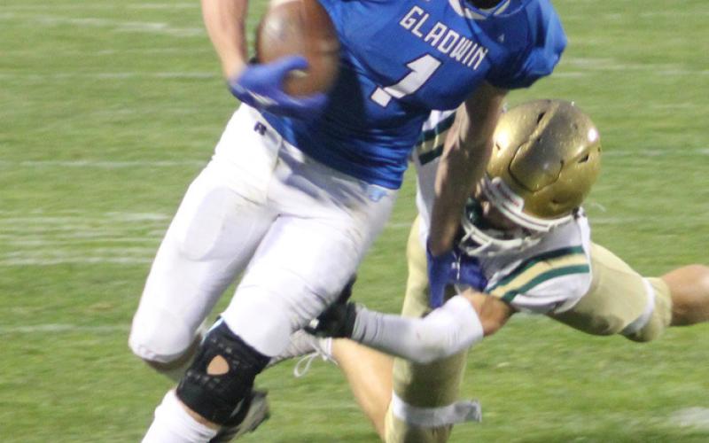 Trace Corlew attempts to sidestep a Pontiac Notre Dame Prep defender.