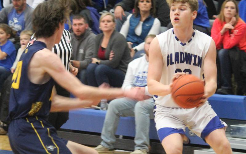 Gladwin’s Dalton Peters attempts to evade a Shepherd defender.