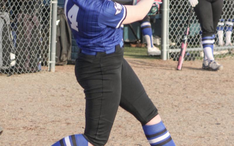 Gladwin’s Elizabeth Mickler takes a cut during Thursday’s season-opening doubleheader against visiting Hemlock.