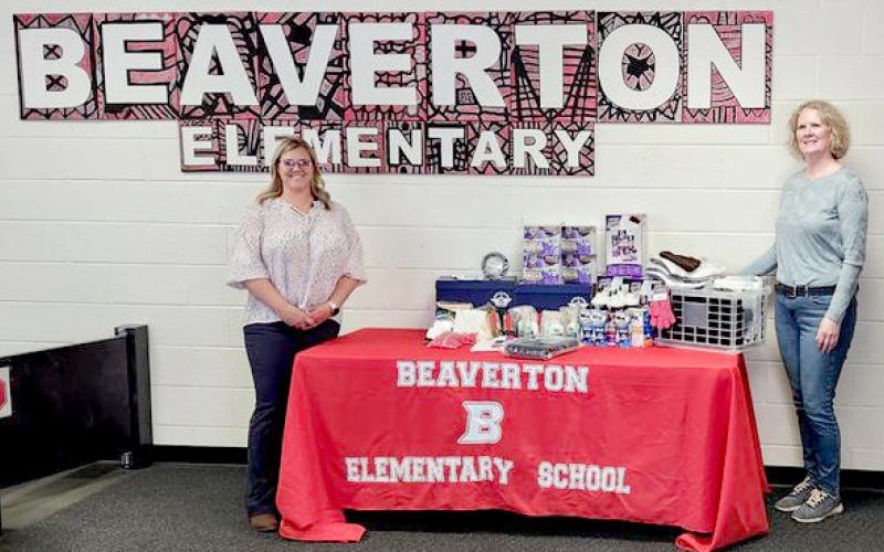 Beaverton Elementary School Principal, Renee Inscho, on left, accepts DAR donation from chair Nancy Pnacek.