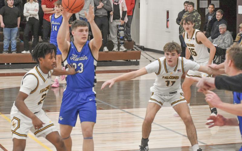Gladwin’s Colton Pfenninger moves the ball around in the paint during Thursday night’s victory at Ogemaw Heights. BY BETH ORR