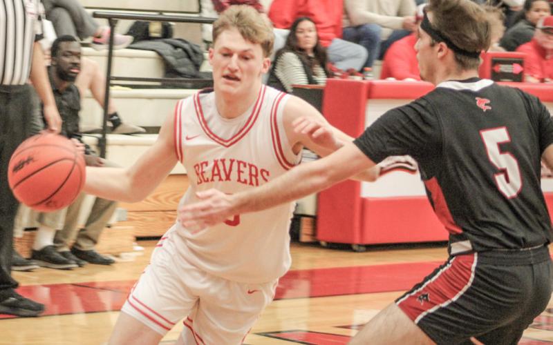 Beaverton’s Ian Roberts drives to the basket past a St. Louis defender on his way to scoring 27 points in last week’s win over St. Louis.