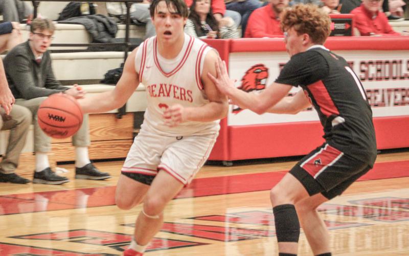 Beaverton’s Landon Love brushes off a defender on his way to the basket during Beaverton’s win over visiting St. Louis last week.