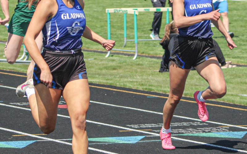 Gladwin’s Kamya Cajigas races to a school record in the 200 meters Saturday at the Jack Pine Conference Meet Saturday, just ahead of previous recordholder Breanna Campbell.