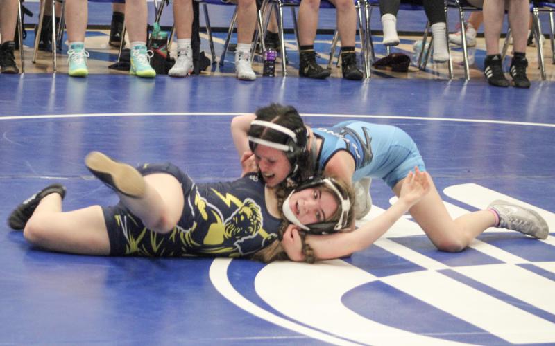Gladwin’s Isabella Leinenger goes for the pin at last week’s dual meet victory over Mio. The sophomore went on to win a gold medal Friday at Manton.
