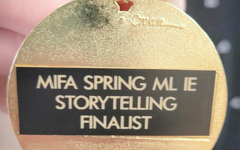 Pictured are Sophia Moore and Sophie Alers-Rivera. Inset photo, at left, Chloie Sprague. Inset photo, at right, is a Storytelling Medal.