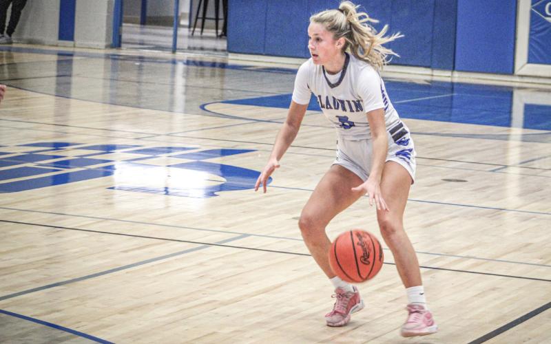 Gladwin point guard Breanna Campbell pounds the rock and looks for an opening in the defense during a recent game.