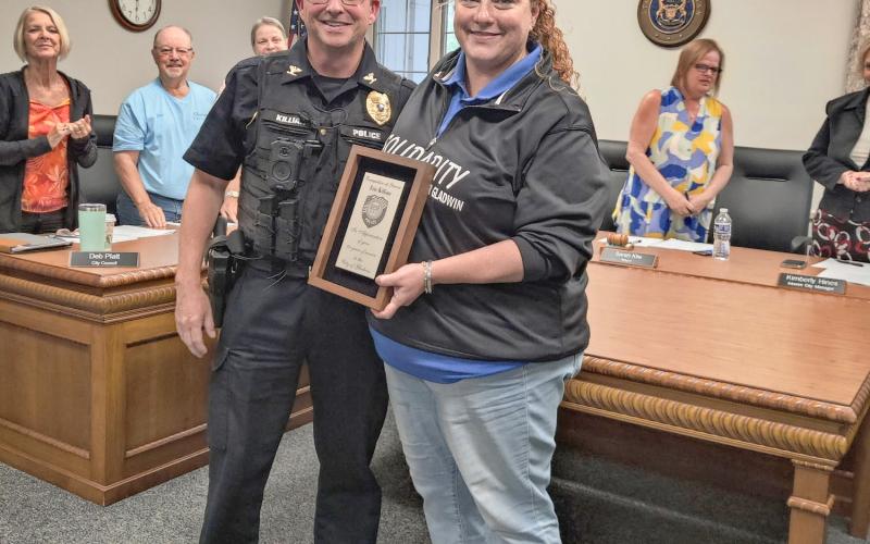 Gladwin Mayor Sarah Kile presents a plaque of appreciation to retiring Chief of Police Eric Killian Monday at an eventful Regular Meeting of the City Council.