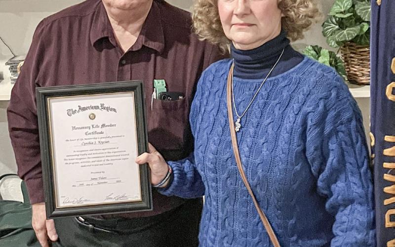 American Legion Post 171 Adjutant Rick Bratton presents Cynthia Krycian with a certificate declaring her an honorary member of the organization.