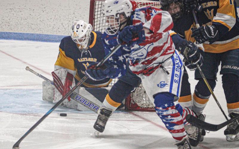 Gladwin’s Moe Newman slides a back-hand shot on goal during the third period of Satuday’s 10-2 victory over Gaylord on Military Appreciation Day.
