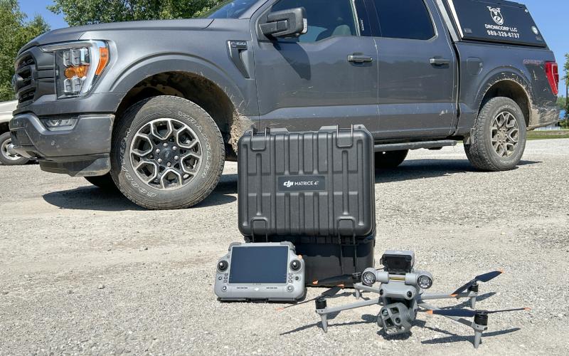 Ryan Baker put all of DroniCorp’s search and rescue equipment to work last week to locate and save Maddie (inset) a Labrador retriever who was lost for three days.