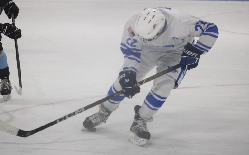 Gladwin’s Landon Woods uses fancy footwork to control the puck Friday night.